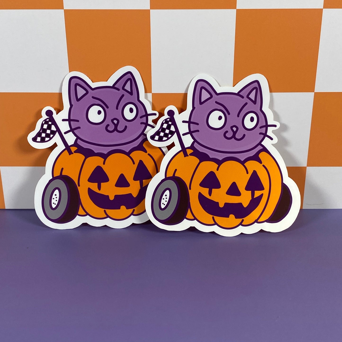 Cheeky purple Cat in a Halloween pumpkin car- Sticker