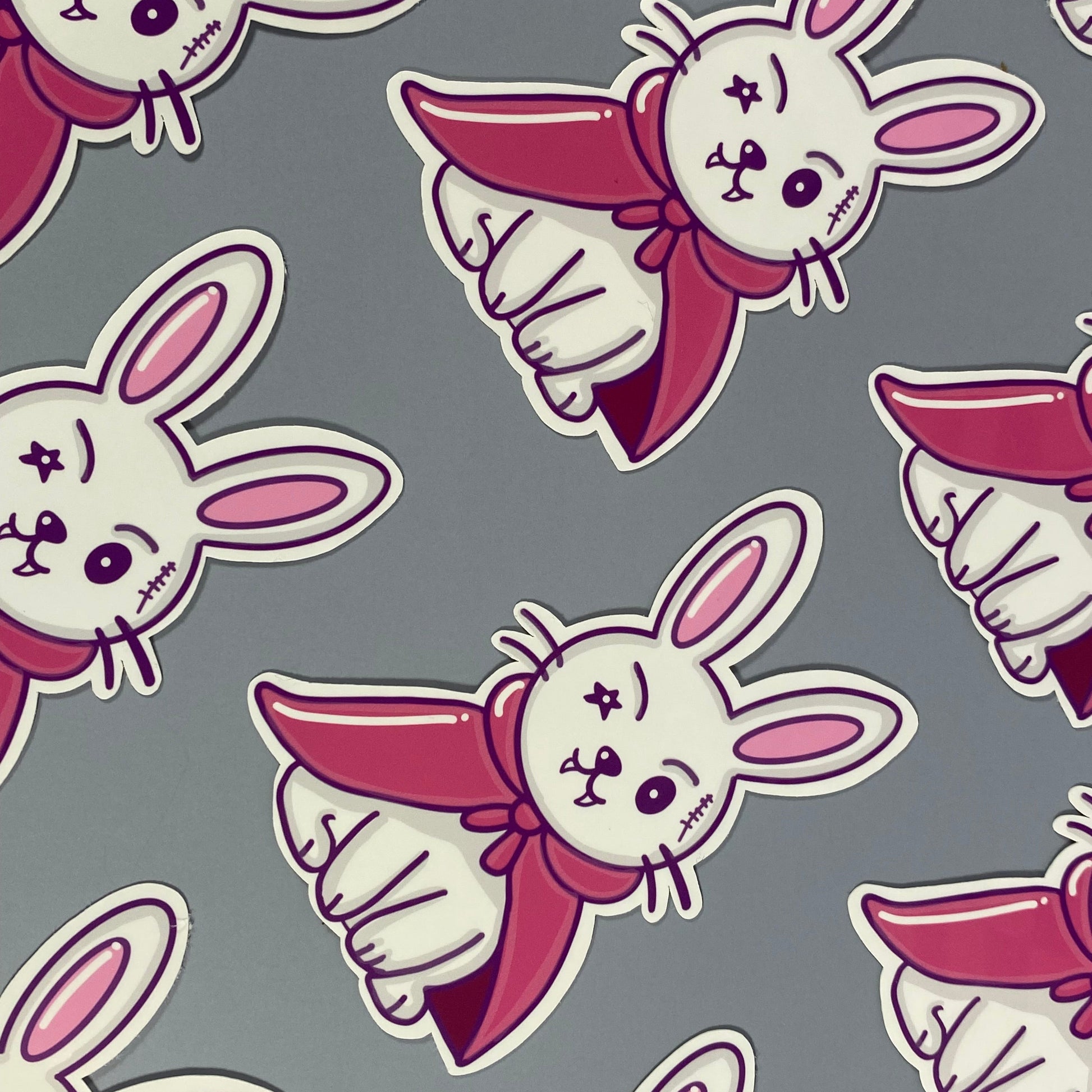 Pattern of cartoon rabbits with pink accents on a gray background