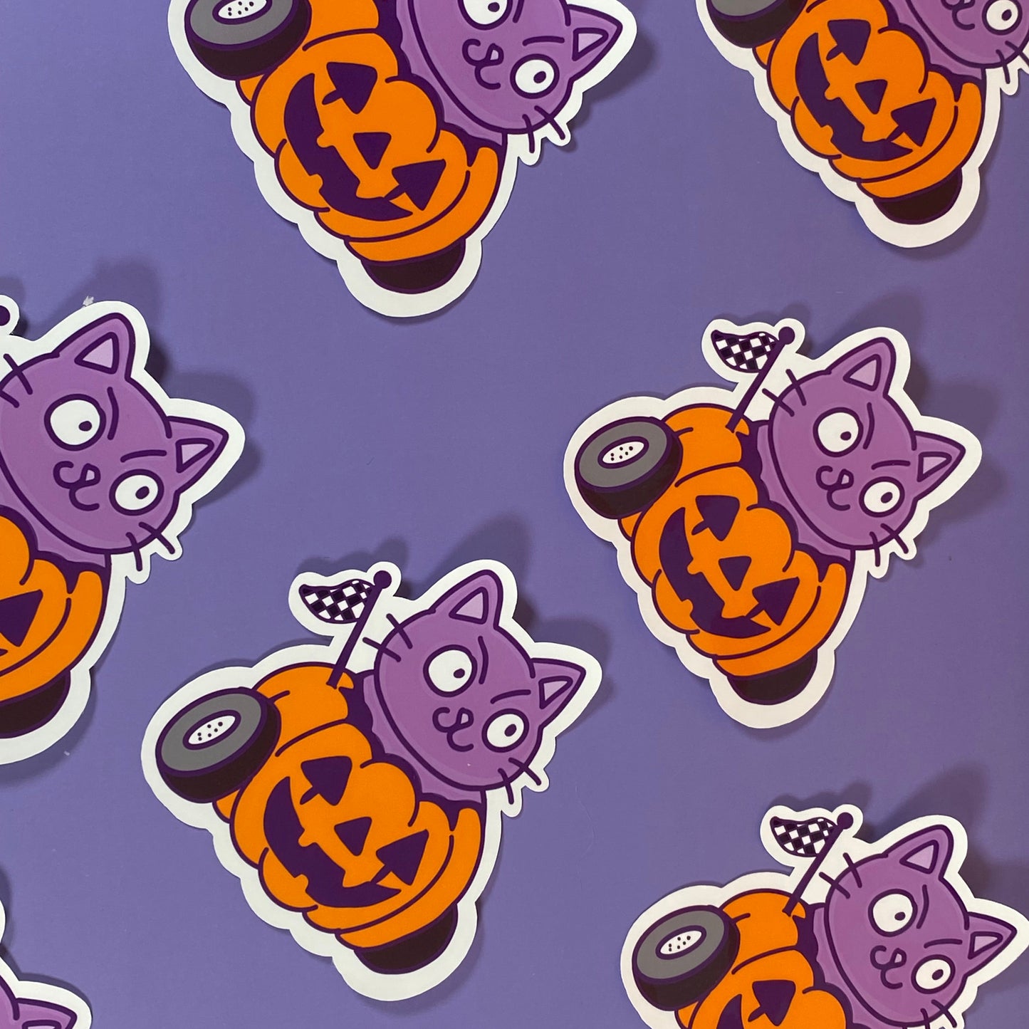 Cheeky purple Cat in a Halloween pumpkin car- Sticker
