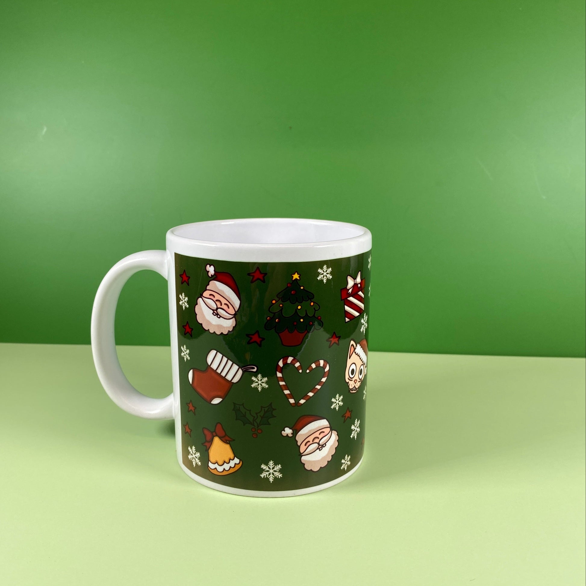 Green mug with festive design on a green background